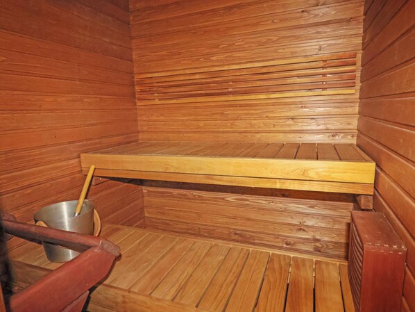 A sauna with wooden walls and benches.