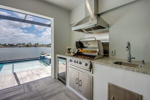 Fridge, microwave, oven, stovetop - Villa Florida Orange -newly built at Eight Lakes, on water, modern, pool & spa (Cape Coral)