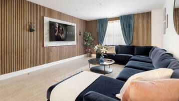 Luxury Duplex, 4 Bedrooms, Air conditioning | Living area | 70-inch LED TV with digital channels, Netflix, Hulu
