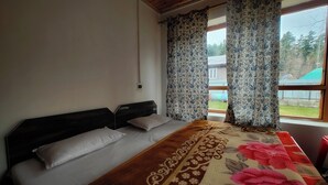A bedroom with a bed, curtains, and a view of the outside. - Royal palace  (Anantnag)