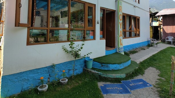 A two-story building with a sign indicating it is a guest house. - Royal palace  (Anantnag)