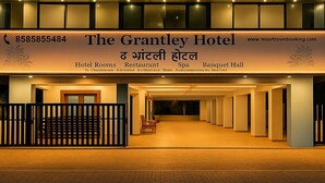 The Grantley Hotel with a signboard displaying amenities like Hotel Rooms, Restaurant, Spa, and Banquet Hall. - The Grantley Hotel (Alibag)
