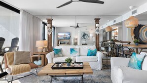 A spacious living room with a modern design, featuring a large sofa set, a coffee table, and a dining area. - Seagrove Beachfront Condo with Incredible Views (Santa Rosa Beach)