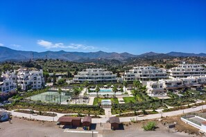 A resort with multiple buildings, a swimming pool, and landscaped gardens.