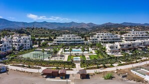 A resort with multiple buildings, a swimming pool, and landscaped gardens. - 3001 Velaya Beachfront Luxury Apartment (Estepona)