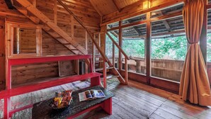 A wooden cabin with a wooden staircase, a bench with snacks, and large windows with curtains. - Alaya Stays Suro Woodbine Chalet Cottage (Kandaghat)