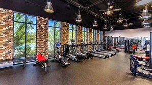 A gym with treadmills, stationary bikes, and weight machines.