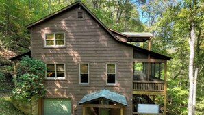 A two-story wooden cabin with a front porch, a garage, and a deck. - Smokey's Place | $179 Off Your Stay! (Blue Ridge)