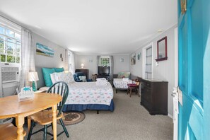 A cozy hotel room with a bed, a desk, a chair, a dresser, and a television. - Studio, Walk to Nauset Beach! (Orleans)