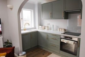 A kitchen with a window, a sink, a toaster, a kettle, and a stove. - Sienna Haven Sleeps 4 With Parking (Birmingham)