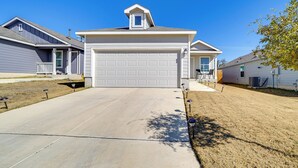 A residential driveway leading to a garage with a sloped roof and a small dormer window. - 7 Mi to Alamo Ranch Mall: Home w/ Large Yard! (San Antonio)
