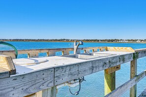 A wooden pier with a metal sink and a hose. - Waterfront Gem w/ Balcony in Garden City (Murrells Inlet)