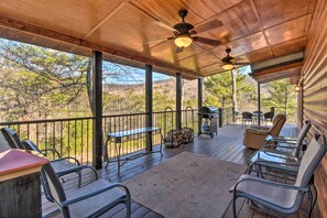 A covered outdoor patio with metal chairs, a table, and a ceiling fan. - Twin Pines Hill House - Fire Pit & Mountain View (Ellijay)