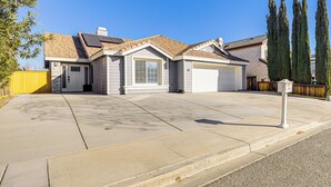 A single-story house with a garage, a front yard, and a mailbox.