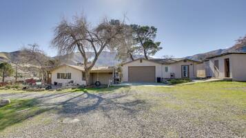 A residential property with a garage, a covered porch, and a driveway.