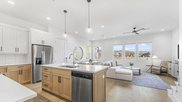 A modern kitchen with white cabinets, stainless steel appliances, and a central island. - Villa #35 At Bloomington Country Club 4 Bedroom Townhouse (St. George)