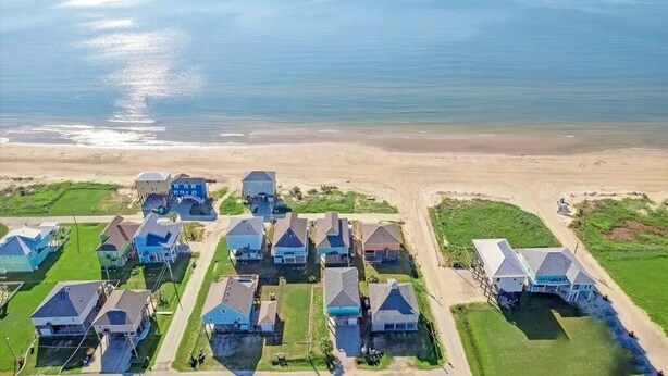 Een woongebied aan de kust met huizen en een strand.
