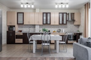 Apartment, Non Smoking, City View | Private kitchen | Full-size fridge, microwave, oven, stovetop - Stylish apartments near metro Vostok (Minsk)