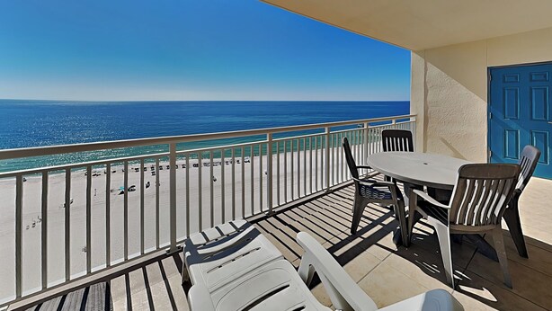 A balcony with a view of the ocean, a table, and chairs. - Admiral's Quarters #1406 | Gulf Front + Amenities (Orange Beach)