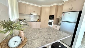 Fridge, microwave, oven, toaster - Retro pet-friendly cottage near beach, river & RSL with air-con, comfortable interiors (Evans Head)