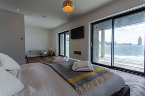 Relax in a spacious room with a large bed, city views, and a flat-screen TV.