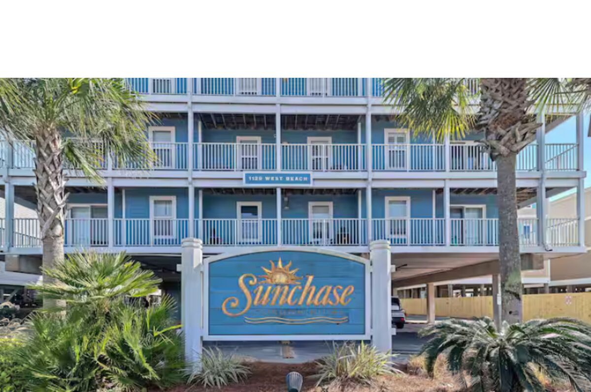 A multi-story building with a sign reading "Sunchase" and "1125 West Beach."