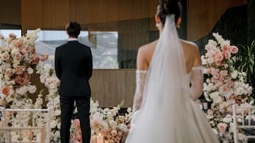 A wedding ceremony with floral decorations and a modern interior.
