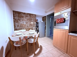 Enjoy meals in this cozy kitchen with a dining table for four, complete with a refrigerator, oven, and microwave.