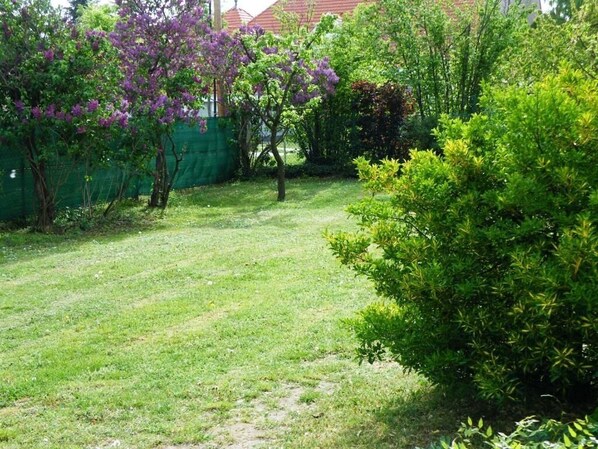 Enjoy a serene and garden setting surrounded by lush greenery and a secure fence.