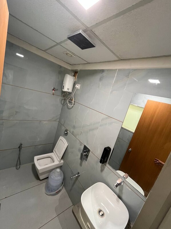 A compact bathroom with a toilet, bidet, and sink.
