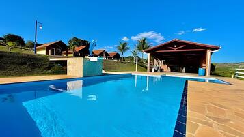 Relax by the resort's clear blue pool surrounded by a spacious deck.