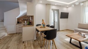A modern apartment with a kitchen, dining area, and living space. - Dream Villas (West Mani)