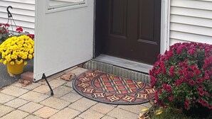 A house entrance with a brown door, a mailbox, and a doormat. - SOFIMA-Cozy and Charming 2-bedroom apartment! (Woburn)