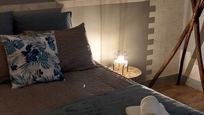 A bedroom with a bed, pillows, a bedside table with a lamp, and a painting on the wall. - Country cottage, Verette cottage (Écueillé)