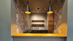 A modern kitchen with a built-in oven, a sink, and two pendant lights. - Long Valley Lodge  (Blönduós)