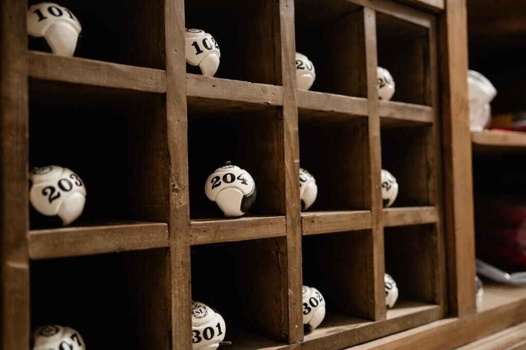 A wooden shelf with numbered balls, likely for a game or activity.