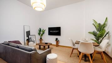Relax in this stylish living room with a sofa, coffee table, and flat-screen TV.