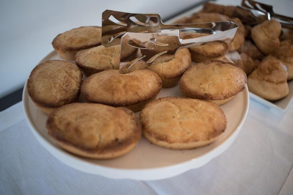A plate of round, golden-brown pastries on a white plate.
