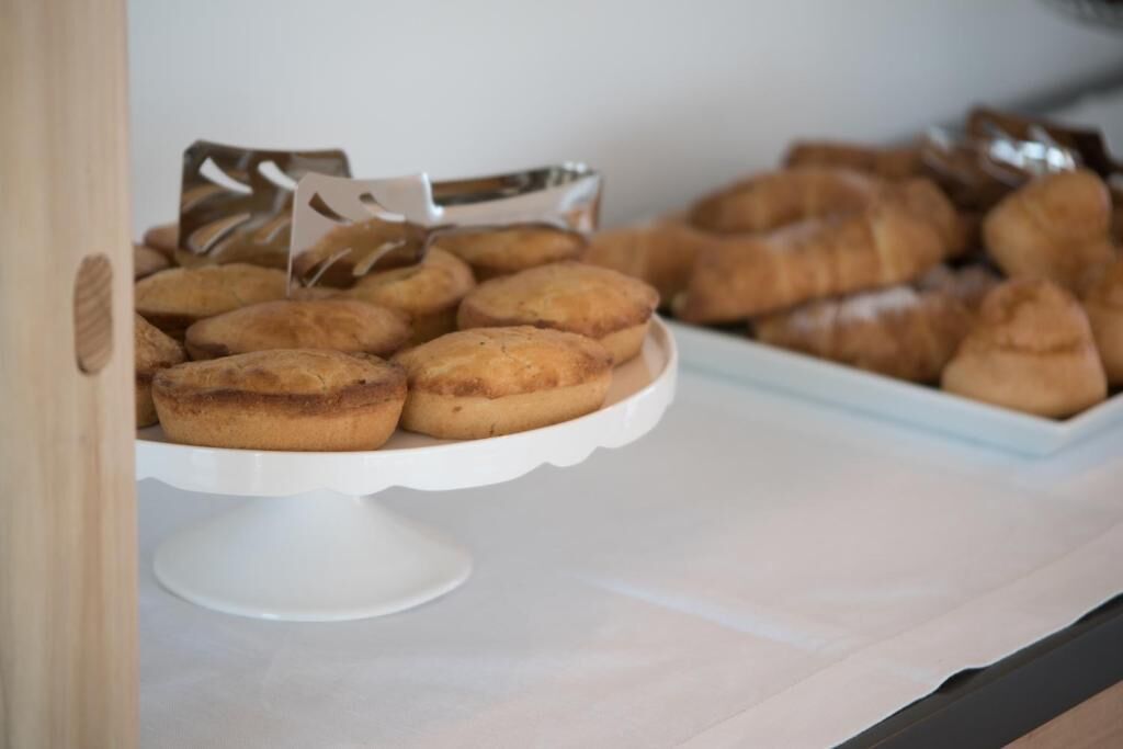 A display of pastries on a white stand.