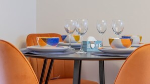 A dining table set with bowls, plates, and wine glasses, with a 'HOME' sign on the table.