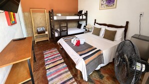 A bunk bed room with a desk, a fan, and a painting on the wall. - Pousada Princesa da Serra (Santana do Riacho)