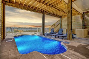 A swimming pool with lounge chairs and a view of the sunset. - Lux 6BR, Lagoon Front, Private Heated Pool, Gulf Views, Boat Dock, Walk To Beach (Gulf Shores)