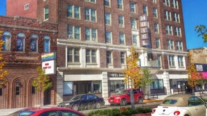 A multi-story brick building with a classic architectural style, featuring large windows and a prominent entrance. - The Androy Hotel - Superior Duluth (Superior)