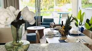 Enjoy a meal in style with a beautifully set dining table near a window offering a view of the outdoors.