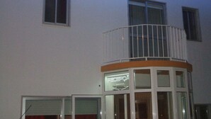 A building with a balcony, a reception area, and multiple windows. - Residencial Pinto  (Guarda)