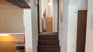 A staircase leading to a bedroom with a wooden dresser and a hanging light fixture. - Rent apartment 3 rooms - sleeps 6, Avoriaz (74) (Morzine)