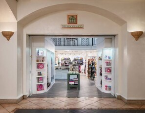 The entrance to The Resort Shops with a tiled floor and a central display table.