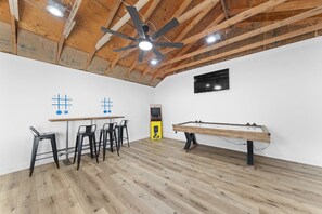 A room with a wooden ceiling, a ceiling fan, a pool table, and a dartboard. - The Getaway House | St Charles 4BR Sleeps 11 Game Room | Hot Tub | Mercer Stays (Saint Charles)