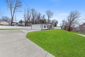 A single-story residential house with a covered porch, a front yard, and a driveway. - The Getaway House | St Charles 4BR Sleeps 11 Game Room | Hot Tub | Mercer Stays (Saint Charles)