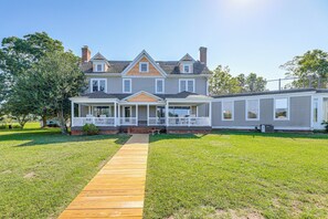 A two-story house with a wooden deck leading to the front porch. - Riverfront Gem w/ Fire Pit in Eden (Eden)